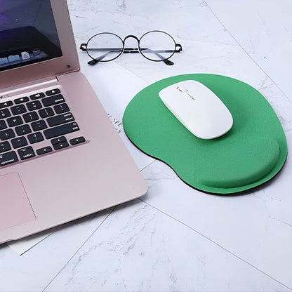 Tapis de souris repose poignée Souris blanche posée sur un tapis de souris ergonomique vert avec repose-poignet, à côté d’un ordinateur portable